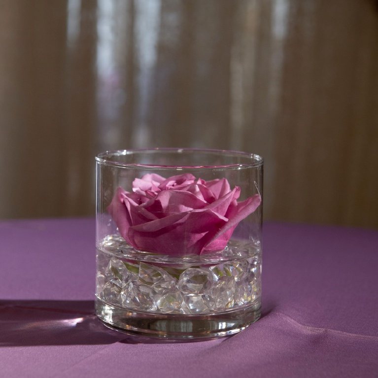 Single rose in glass votive