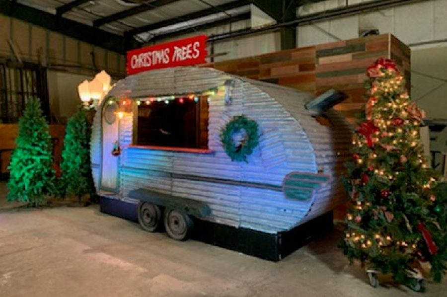 Vintage camper trailer styled as a Christmas tree lot bar