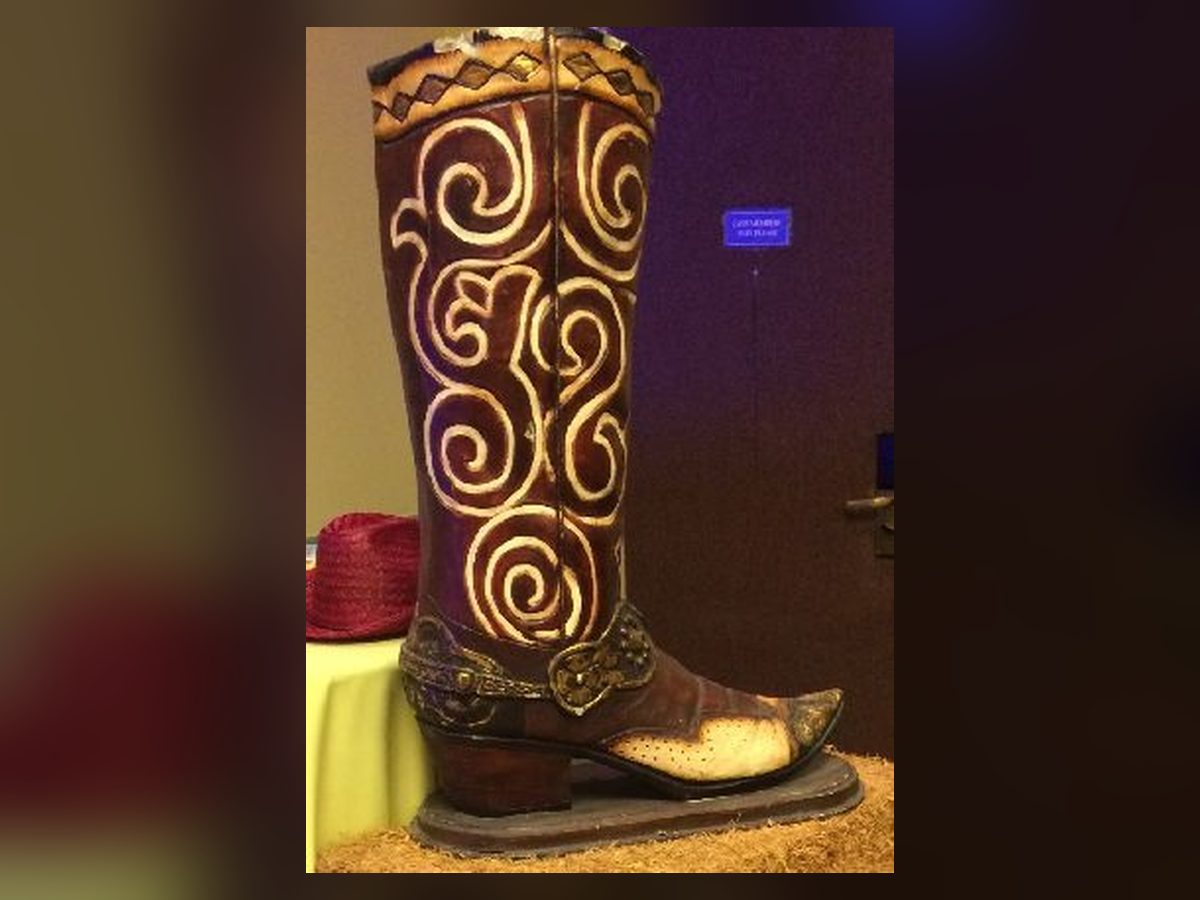 Oversized carved cowboy boot statue