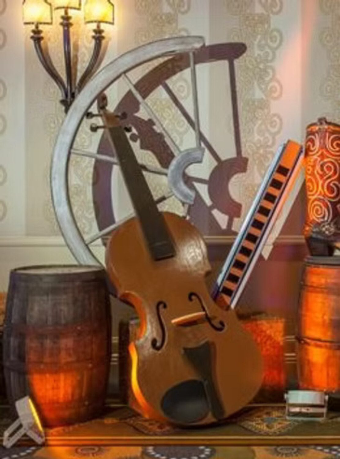 Oversized fiddle prop with harmonica and barrels