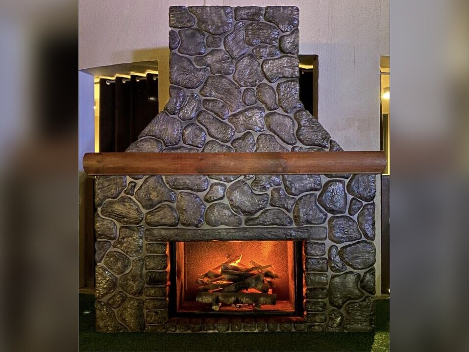 Stone fireplace facade with mantel