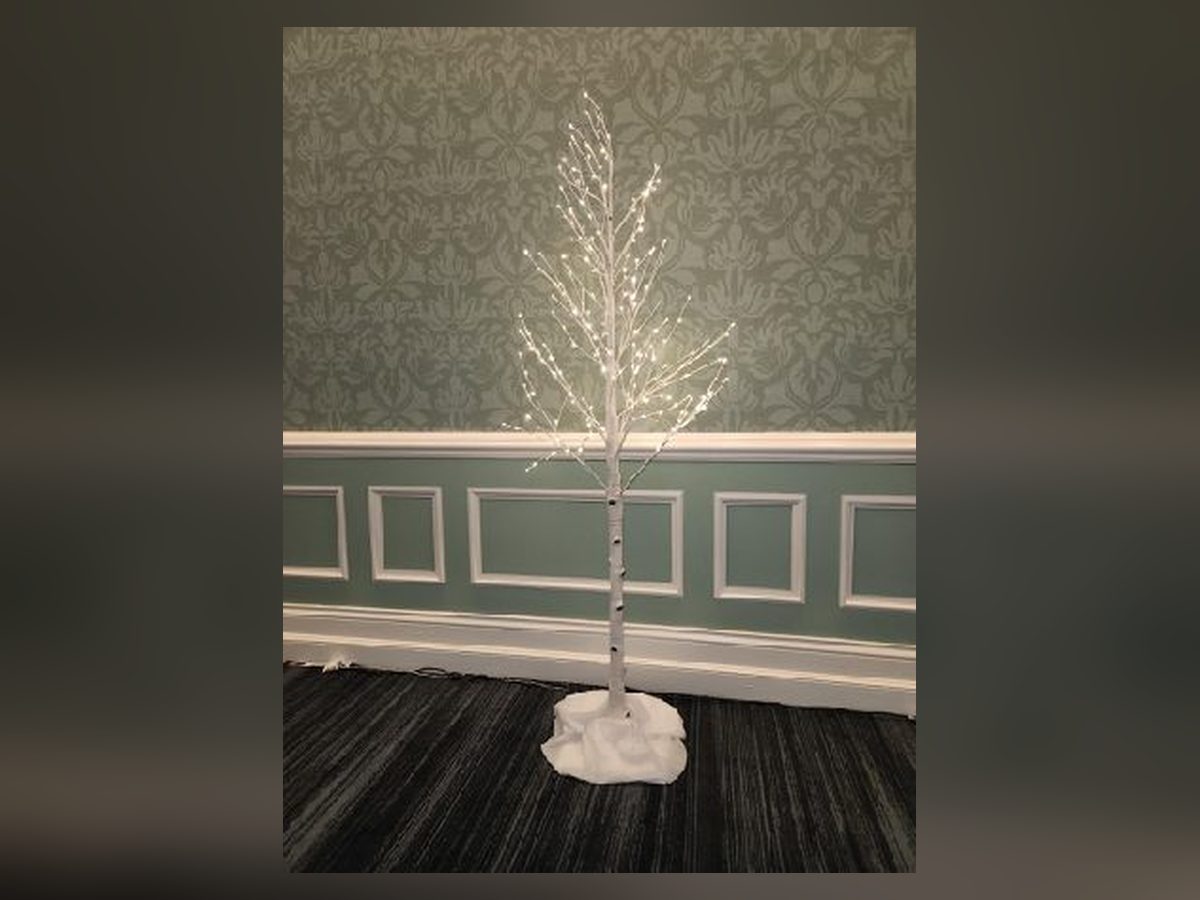 Lighted white birch tree with cotton snow blanket