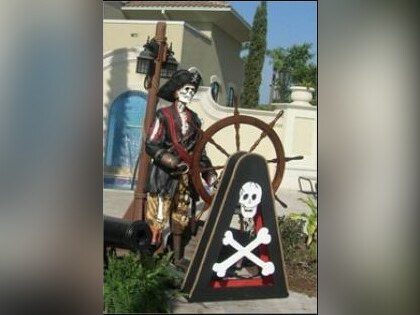 Pirate skeleton statue at the ship's wheel