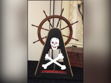 Pirate ship's wheel with skull and crossbones