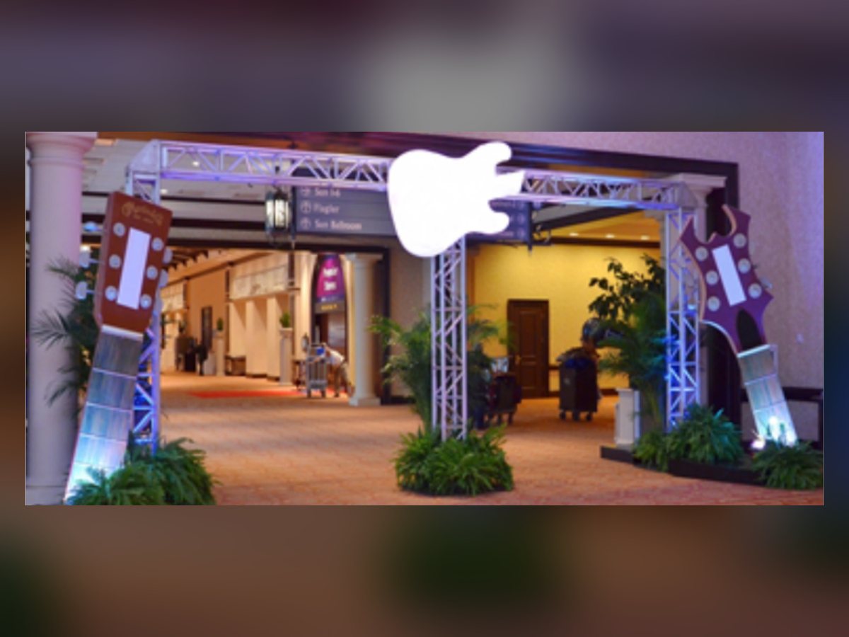 Rock and roll truss entry with guitar toppers and stage lighting