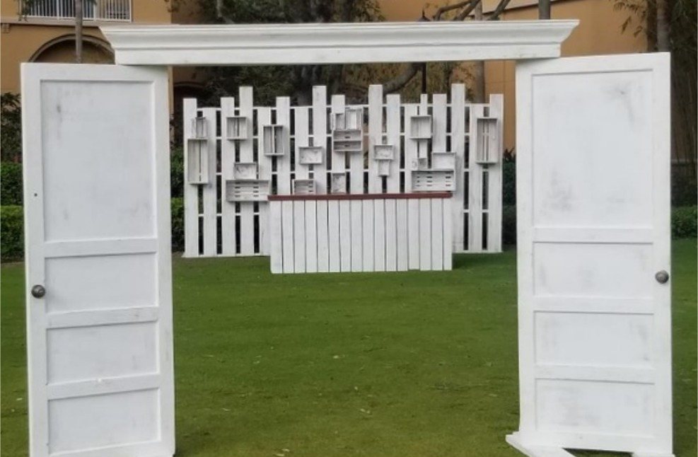 Whitewashed double door entry with picket fence